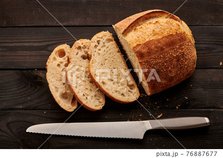 Homemade tartine bread on dark wooden table 76887677