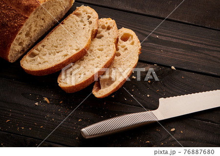 Homemade tartine bread on dark wooden table 76887680