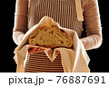 Baker holding loaf of homemade bread 76887691