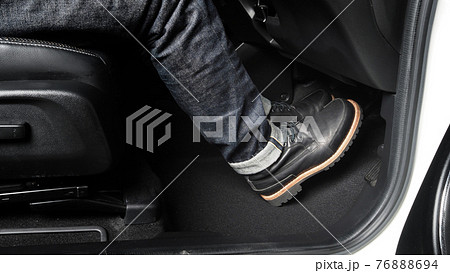 Close up the foot pressing foot pedal of a car to drive. Accelerator and brake pedal in a car. Driver driving the car by pushing accelerator and break pedals of the car. inside vehicle. control pedal. Close up the foot pressing foot pedal of a car to drive. Accelerator and brake pedal in a car. Driver driving the car by pushing accelerator and break pedals of the car. inside vehicle. control pedal. 76888694