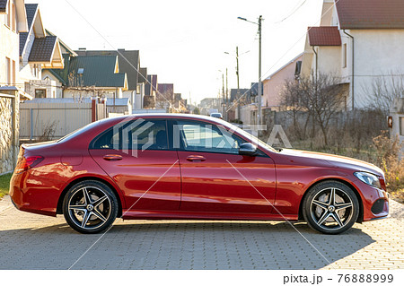 Frankfurt, Germany - September 27, 2020: New bright red Mercedes Benz C-class parked outside on a street. 76888999