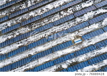 Blue solar photo voltaic panels system producing renewable clean energy in rural area in winter. Blue solar photo voltaic panels system producing renewable clean energy in rural area in winter. 76889428
