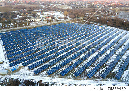 Blue solar photo voltaic panels system producing renewable clean energy in rural area in winter. 76889429