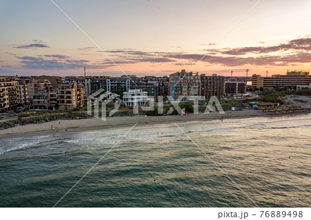 Aerial view of Pomorie city that is located on Black Sea shore. Top view of sand beaches with many hotel buildings and tourist infrastructure. 76889498