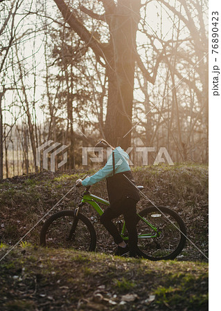 woman riding on bicycle 76890423
