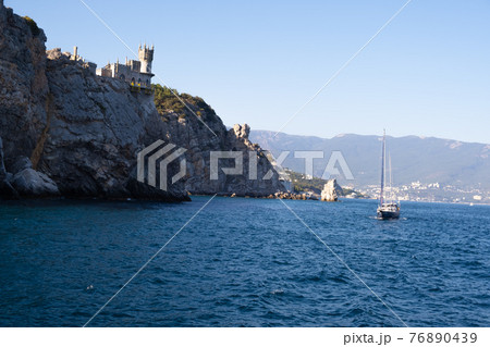 Beautiful landscape with yachts on the sea against the background of the Swallows Nest - an ancient Beautiful landscape with yachts on the sea against the background of the Swallows Nest - an ancient 76890439