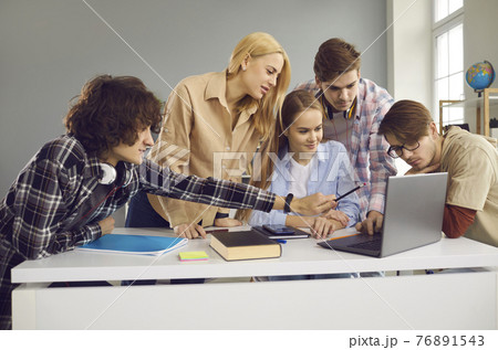 Creative school, college or university students working on group project and using laptop Creative school, college or university students working on group project and using laptop 76891543