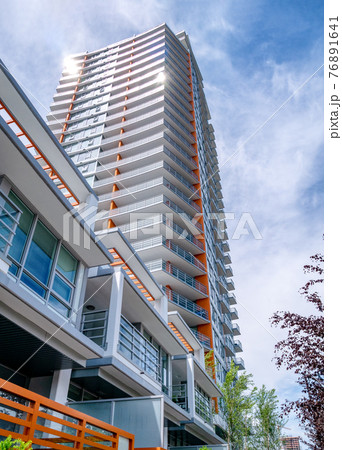 Brand new high-rise building on blue and white sky background 76891641