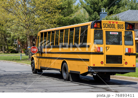 School bus on american town road in the morning School bus on american town road in the morning 76893411