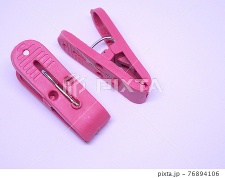 Red plastic clothespin isolated on white background  76894106