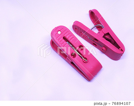 Red plastic clothespin isolated on white background  76894107