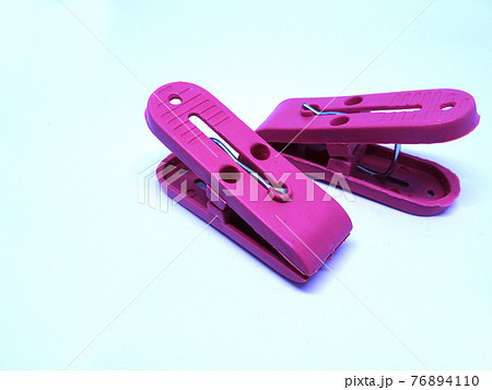 Red plastic clothespin isolated on white background  76894110