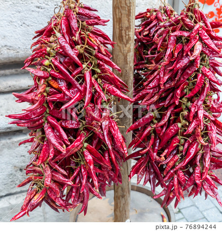 chili peppers sun drying, garland outdoor traditional way chili peppers sun drying, garland outdoor traditional way 76894244