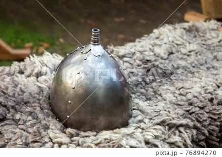 iron helmet on the background of the skins part of the warrior's uniform iron helmet on the background of the skins part of the warrior's uniform 76894270