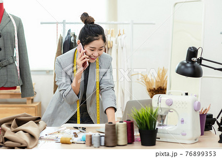 Asia young women fashion designer using laptop working and received order customer for design  76899353