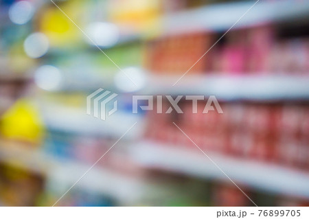 Blurred food and drink on shelf in super market with cart 76899705