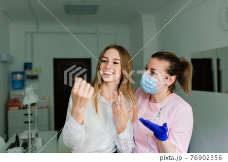 Female manicure master in a beauty salon work with hands of the client 76902356