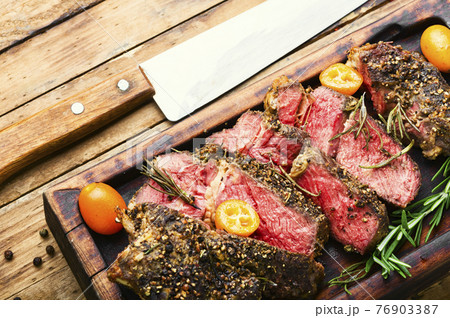 Succulent veal steak with kumquat 76903387