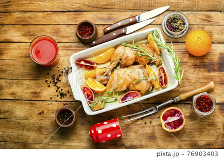 Tasty chicken drumstick baked with oranges,top view Tasty chicken drumstick baked with oranges,top view 76903403