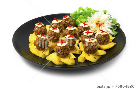 Thai Appetizer Pineapple Fruits Served with Sweet and Savory Peanut and Minced Pork Sauce 76904930