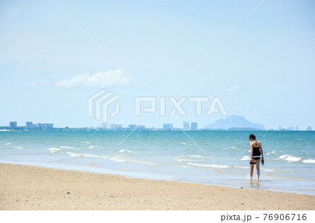 woman walk on the beach 76906716