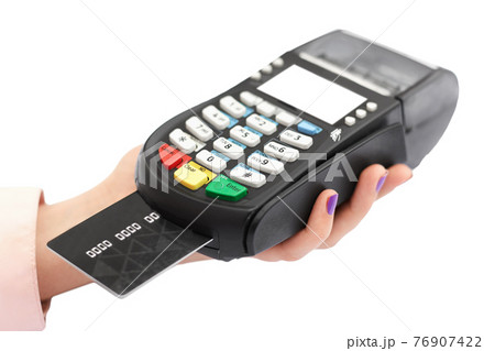 Isolated shot of woman`s hand holds payment terminal and plastic card for paying in shop without cash, swips credit card in store. Electronic payment concept 76907422