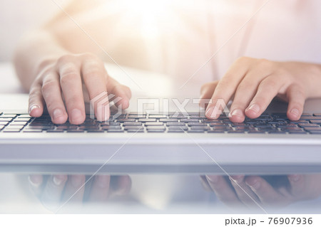 Woman typing on keyboard of PC on white background, female writing text on note book, man hands on keyboard, lap top on table, faceless portrait, programmer working online. Technology concept. 76907936