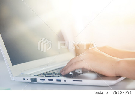 Woman working at lap top with blank screen, female's hands on keyboard of PC, online work, girl having online work, girl typing text, faceless portrait of office worker. Modern technology concept. 76907954