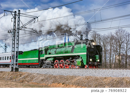 Steam retro train moves from the station. Steam retro train moves from the station. 76908922