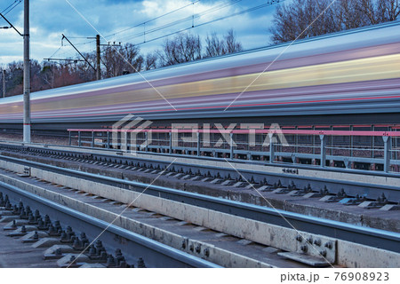 Passenger train moves along the forest. Passenger train moves along the forest. 76908923