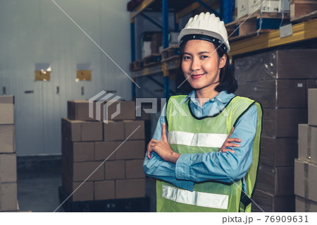 Portrait of young Asian woman warehouse worker smiling in the storehouse 76909631