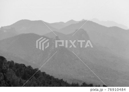 Atmospheric view of Pentadaktylos mountain peaks viewed from Kantara area, Cyprus, in monochrome 76910484