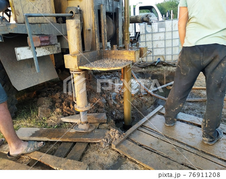 A groundwater drilling machine installed on an old truck performs well drilling on a private site. 76911208