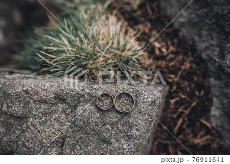 wedding rings bride and groom on the background 76911641