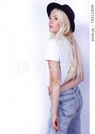young pretty blond girl hipster in hat on white background casual close up dreaming smiling posing cheerful, lifestyle people concept 76912899