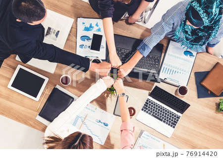 Teamwork business people join hands in meeting. Teamwork business people join hands in meeting. 76914420