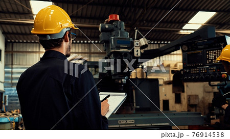 Skillful factory worker working with clipboard to do job procedure checklist . Skillful factory worker working with clipboard to do job procedure checklist . 76914538
