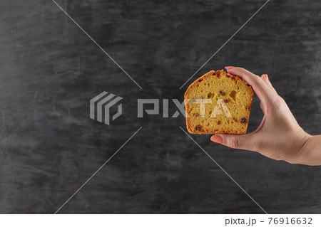 Holding a slice of pie with black sultana in it Holding a slice of pie with black sultana in it 76916632