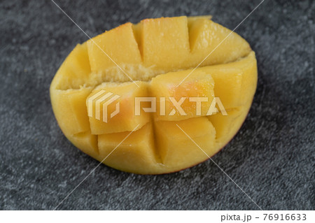 Slice of yellow mango on the grey marble 76916633