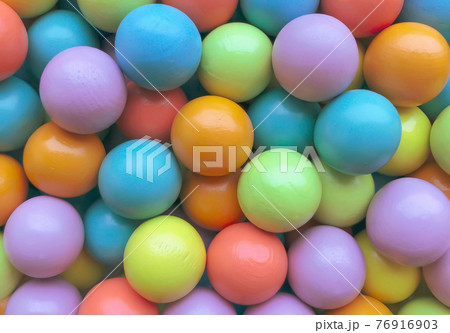Background from multicolored bright small wooden balls of blue, yellow, red, lilac and green colors. A beautiful summer bright background for your projects. Background from multicolored bright small wooden balls of blue, yellow, red, lilac and green colors. A beautiful summer bright background for your projects. 76916903