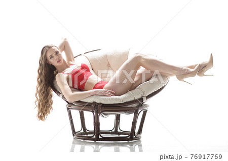 beautiful woman in red underwear lying in a chic chair.isolated on white beautiful woman in red underwear lying in a chic chair.isolated on white 76917769