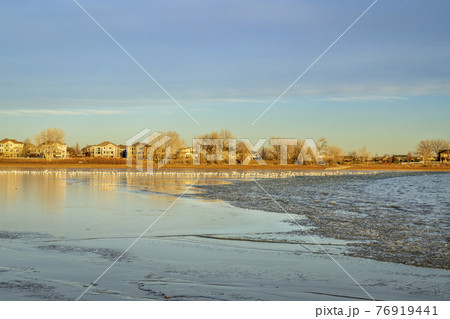 freezing lake at sunset freezing lake at sunset 76919441