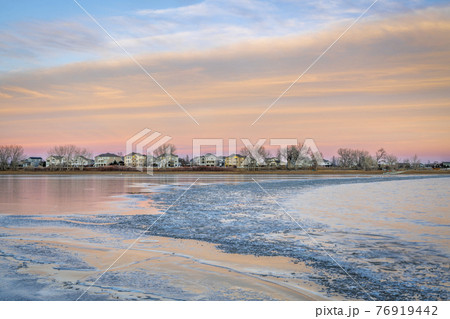 freezing lake after sunset freezing lake after sunset 76919442