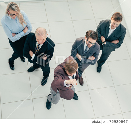 top view. leader and a group of employees standing together. top view. leader and a group of employees standing together. 76920647