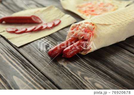 close up.sausage in pita bread on wooden background 76920678