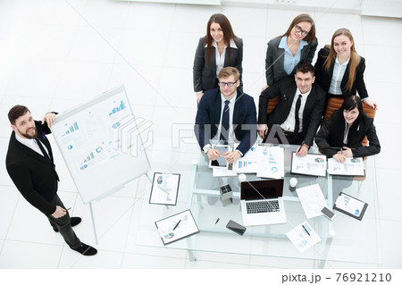 business coach teaching employees on whiteboard at corporate training 76921210