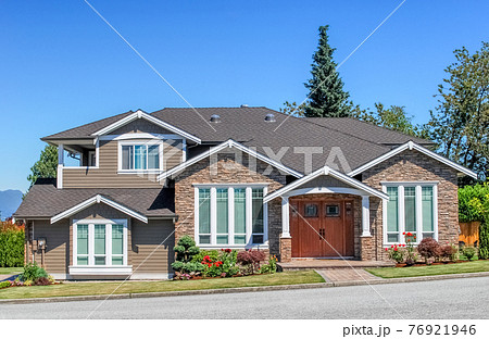 Luxury residential house with landscaped front yard and pawed pathway over it Luxury residential house with landscaped front yard and pawed pathway over it 76921946