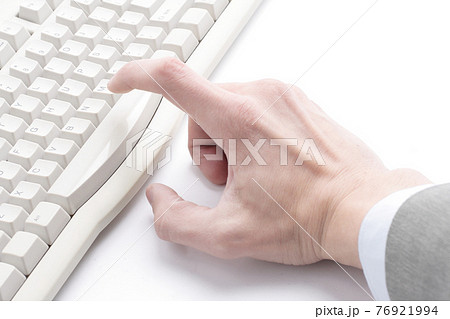 finger hit the button on the old computer keyboard 76921994