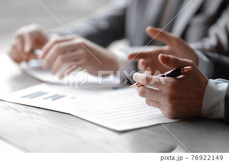 close up businesswoman hand holing pen and pointing on statistic stock graph profit paper for explaining data information close up businesswoman hand holing pen and pointing on statistic stock graph profit paper for explaining data information 76922149