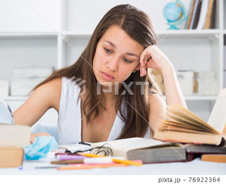 Female teenager is solving an equation Female teenager is solving an equation 76922364